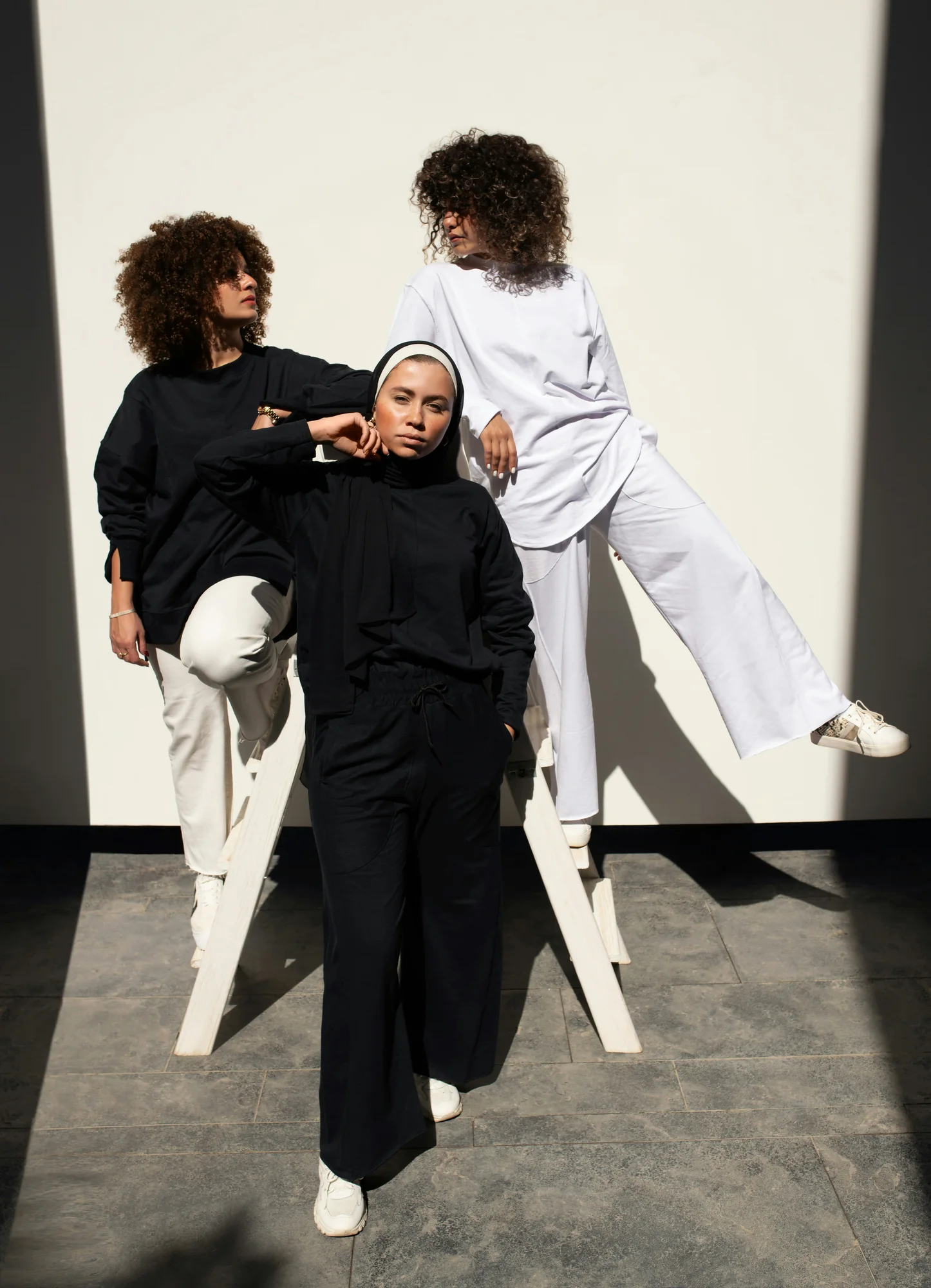 Models wearing minimalist black and white streetwear apparel